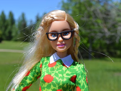 A barbie doll in glasses.