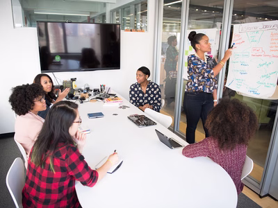 A team meeting taking place in a meeting room.