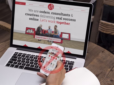 A MacBook and an iPhone showing a site that has been shrunk to fit the phone.