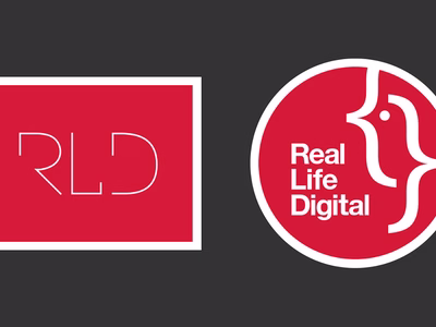 The old RLD Real Life Design logo next to the new circular Real Life Digital logo on a dark grey background.
