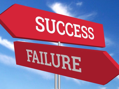 Two road signs - one pointing to success and the other pointing to failure.