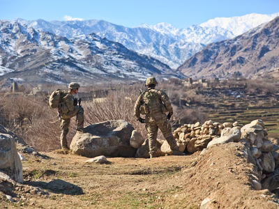 Two soldiers in Afghanistan framed by the beautiful landscape.
