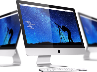 The Telaugos Solutions website on three iMacs.