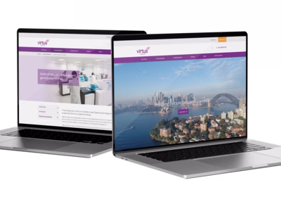 Virtus Health corporate website shown on a couple of MacBook laptops.