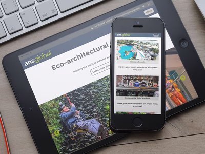 ANS Global: Company Website Living Wall Applications page on an Apple iPhone which is sat on top of an iPad.