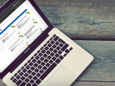 Argus Media: Africa Fertilizer Directory Website Home page on an Apple MacBook which is sat on a wooden desk.