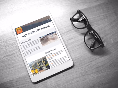 CUTcnc: Company Website Home page on an Apple iPad. Next to the device is a pair of thick rimmed glasses lying on the desk.