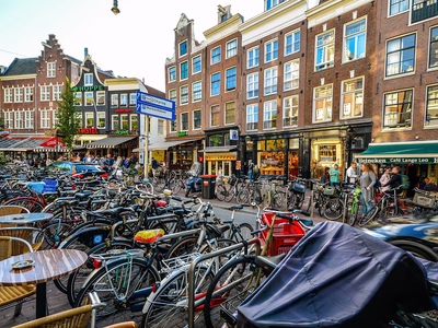Hundreds of bikes in one of Amsterdam's bustling streets.