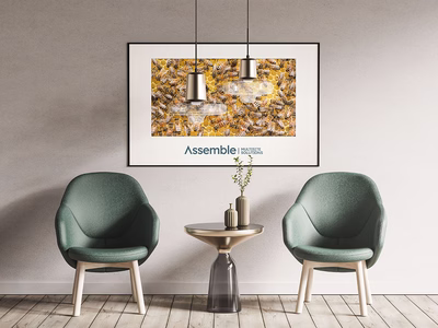 A well designed room featuring a large piece of wall art featuring a bee hive and the Pivale Assemble: Multisite Solutions branding.