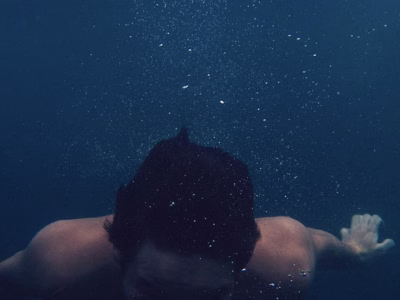 A man immersed in very deep water without breathing equipment.
