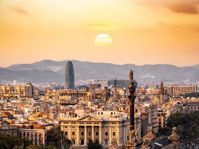 The sun sets over the cityscape of Barcelona.