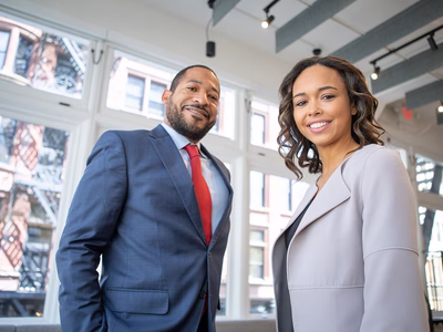 A man and a women smiling at the camera.