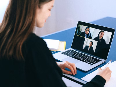 A video conference call taking place on a laptop.
