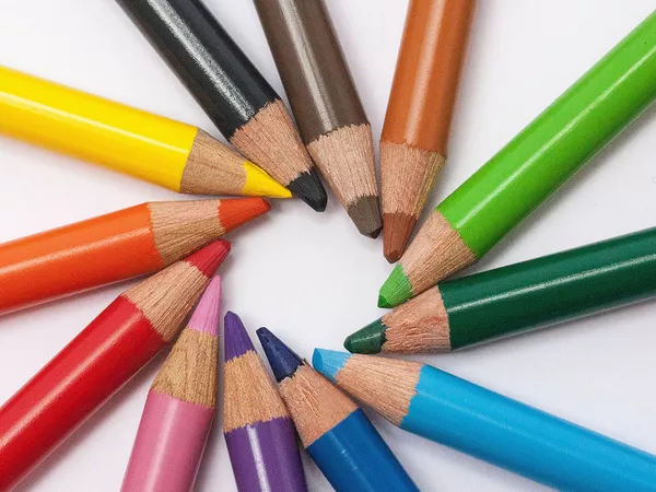 Coloured pencils artfully placed together to forma a spiral.