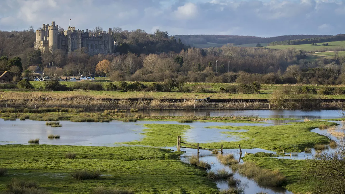 Arundel Castle, West Sussex, England. The river has flooded the fields.