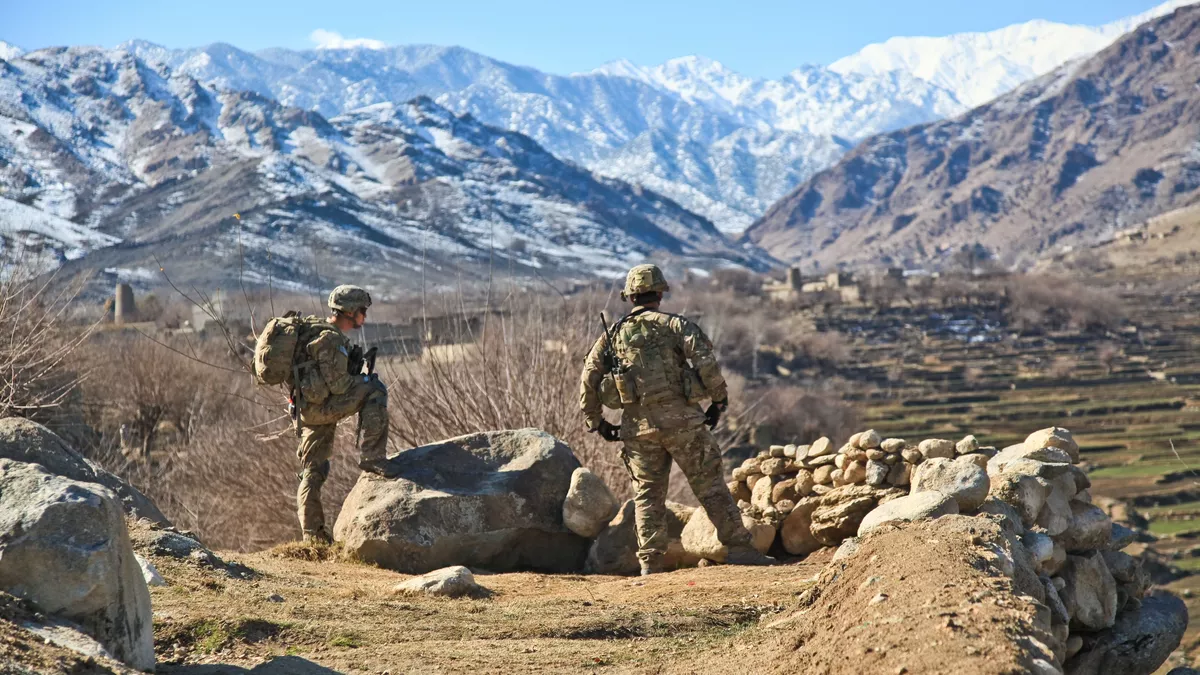 Two soliders in Afghanistan framed by the beautiful landscape.