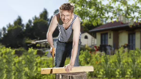 A man embarking on some DIY in a vest top.