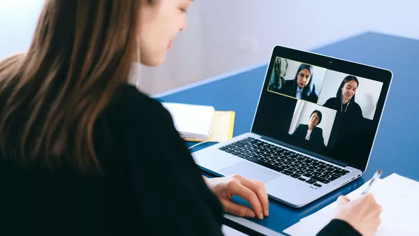 A video conference call taking place on a laptop.