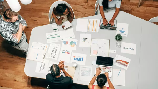 People in an agency office discussing a project.