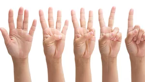 Five hands showing five through one digits elevated to indicate a countdown.