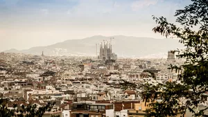 The city of Barcelona from afar. The prominent and recognisable landmark La Sagrada Familia towers above the city.