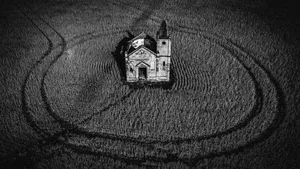 The ruins of a building in the middle of a field.