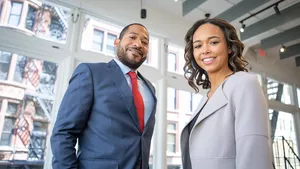 A man and a women smiling at the camera.