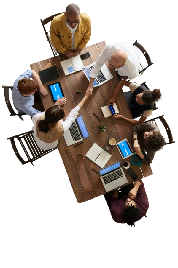 A group of people sat around a table working collaboratively.